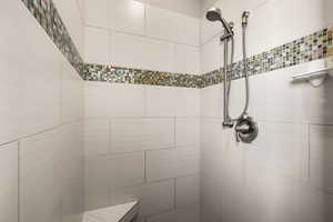 Main bathroom featuring a tile shower