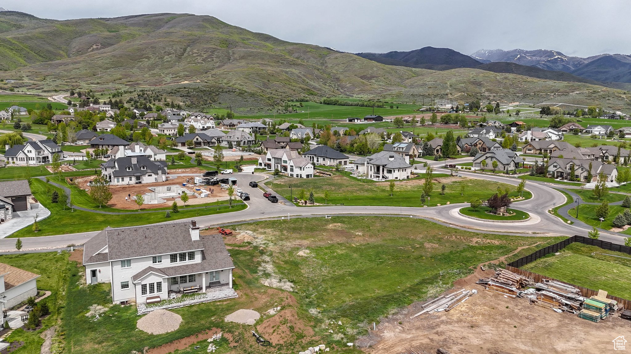 Aerial overview of property's location featuring nearby suburban area and a mountainous background