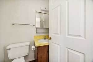 Half bath featuring vanity and toilet