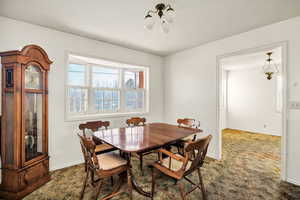 Dining space with carpet and baseboards