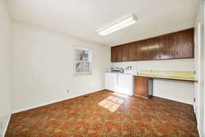 Kitchen featuring dark brown cabinets, light countertops, and washer and dryer