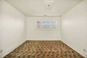 Empty room with carpet and baseboards