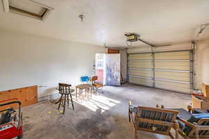 Garage featuring a garage door opener