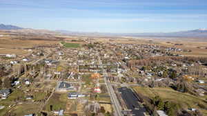Aerial view of property and surrounding area with a mountainous background and rural landscape