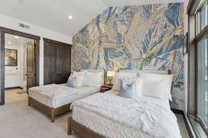 Bedroom featuring vaulted ceiling, an accent wall, a closet, and recessed lighting