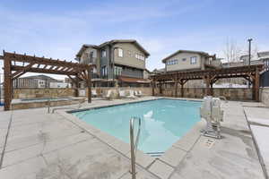 Community pool featuring a pergola, a patio area, and a community hot tub