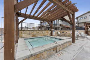 View of swimming pool featuring a pergola, a patio, and a hot tub