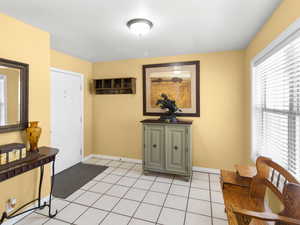 Foyer entrance featuring baseboards and light tile patterned floors
