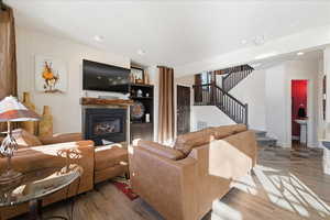 Open floor plan living room w/ LVP flooring, gas fireplace and 9' ceilings.