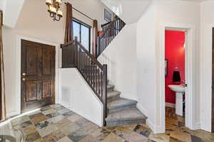 Foyer with vaulted ceilings and slate floors.