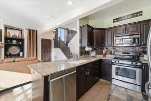 Kitchen with stainless appliances and updated backsplash.