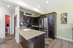 Kitchen with stainless appliances and updated backsplash.