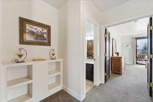 Hall Corridor w/ built-in shelves and Laundry Shoot.