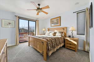 Primary Bedroom w/ 8' sliding glass doors to oversized deck, Updated En-Suite bathroom and walk in closet.