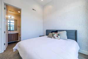 Bedroom with ensuite bath and recessed lighting