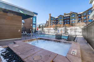 Community pool with a community hot tub and a patio