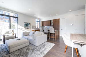 Living room featuring dark wood finished floors and recessed lighting