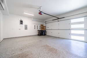 Garage with electric panel and a garage door opener