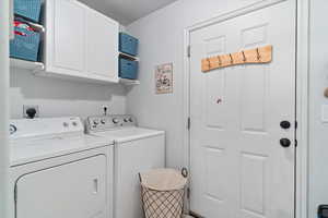 Laundry room with cabinet space and washing machine and dryer