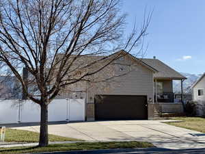 View of front of house with brick siding, driveway, a porch, a garage, and roof with shingles