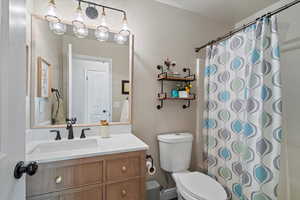 Bathroom with a shower with curtain and vanity