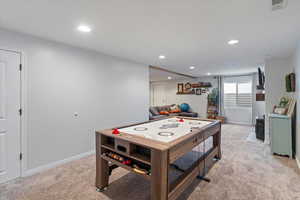 Game room with light carpet and recessed lighting