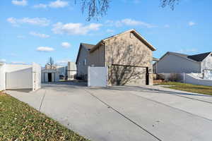 Back of property featuring driveway and an attached garage
