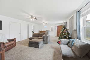 Living area with carpet floors and plenty of natural light