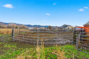 Stable featuring a mountain view and a view of rural / pastoral area