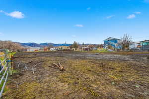 View of yard with a mountain view and a rural view