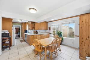 Dining area featuring light tile patterned floors and baseboards