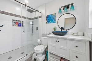 Bathroom with vanity and a shower stall