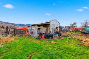 View of pole building with a mountain view