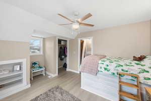 Bedroom with a closet, light wood finished floors, and a ceiling fan