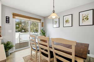 Dining area featuring light wood-style floors and baseboards