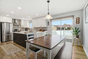 Dining area featuring light wood-type flooring and recessed lighting