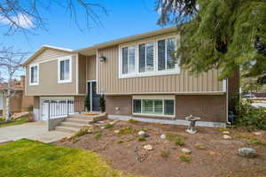 Bi-level home with driveway and an attached garage