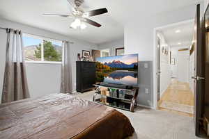 Bedroom featuring ceiling fan and baseboards