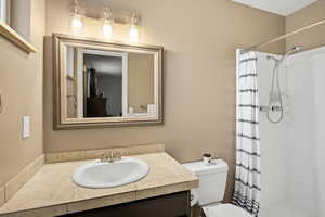 Bathroom with a shower stall and vanity