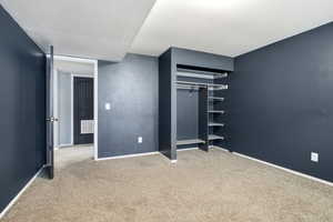 Unfurnished bedroom featuring light colored carpet and a closet
