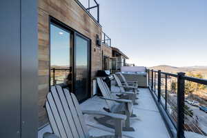 Balcony featuring a mountain view and grilling area