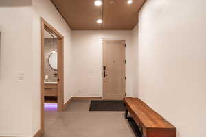 Foyer entrance with recessed lighting and wood ceiling