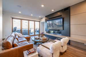 Living room featuring wood finished floors and recessed lighting