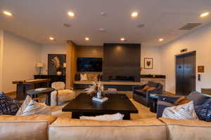 Living room with elevator and recessed lighting