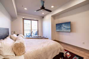 Bedroom featuring wood finished floors, recessed lighting, and a ceiling fan