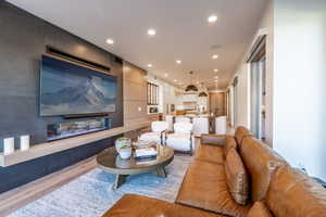 Living area featuring recessed lighting and light wood-style flooring
