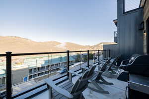 Balcony with a mountain view and area for grilling