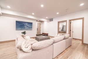 Living room featuring recessed lighting and light wood-style flooring