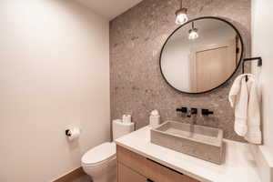 Bathroom with vanity and decorative backsplash