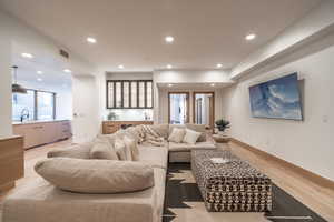 Living room featuring light wood-style flooring and recessed lighting